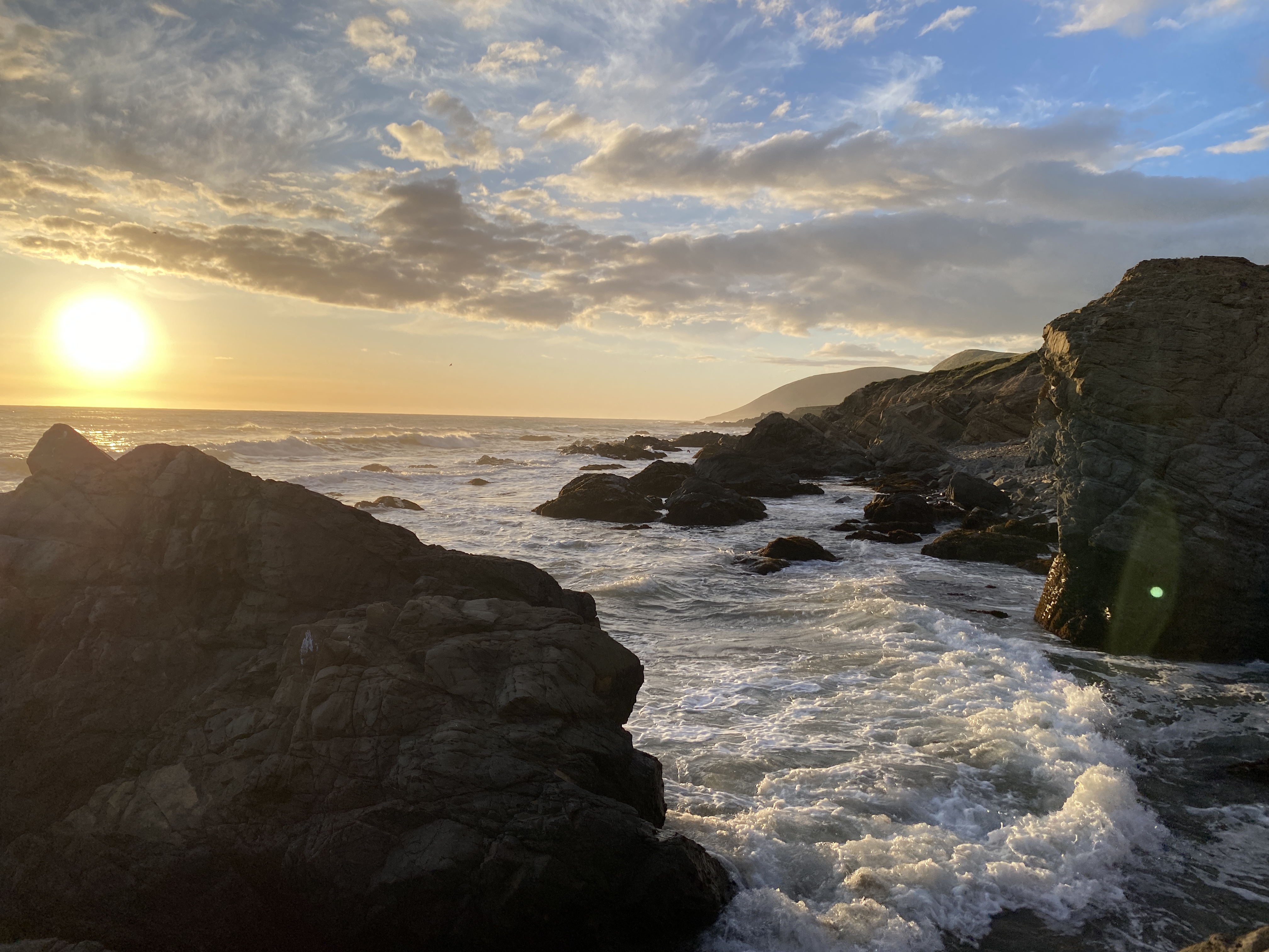 An image of a rocky beach at sunset